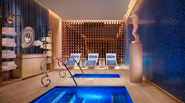 Luxury home spa with a large steam room, sauna, and massage table