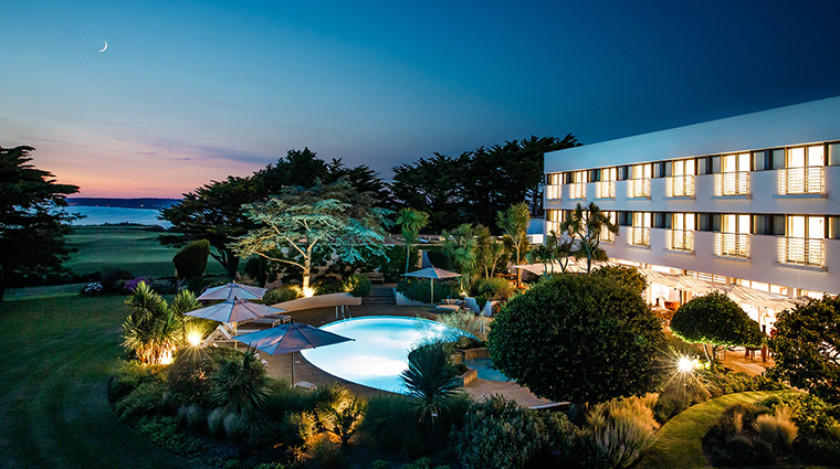 the atlantic hotel night time exterior pool and gardens panorama