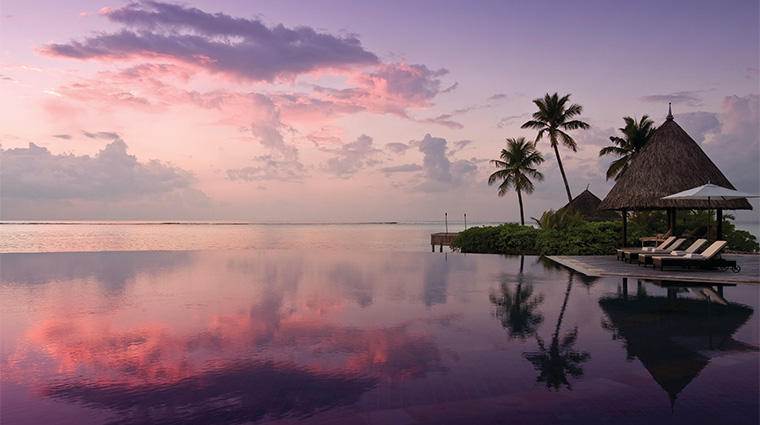 the island spa at four seasons resort maldives at kuda huraa pool sunset