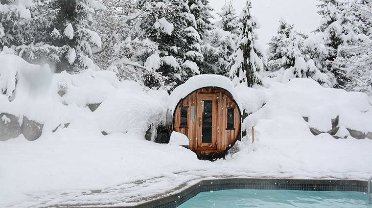 the spa at four seasons resort and residences whistler snow covered barrel sauna exterior